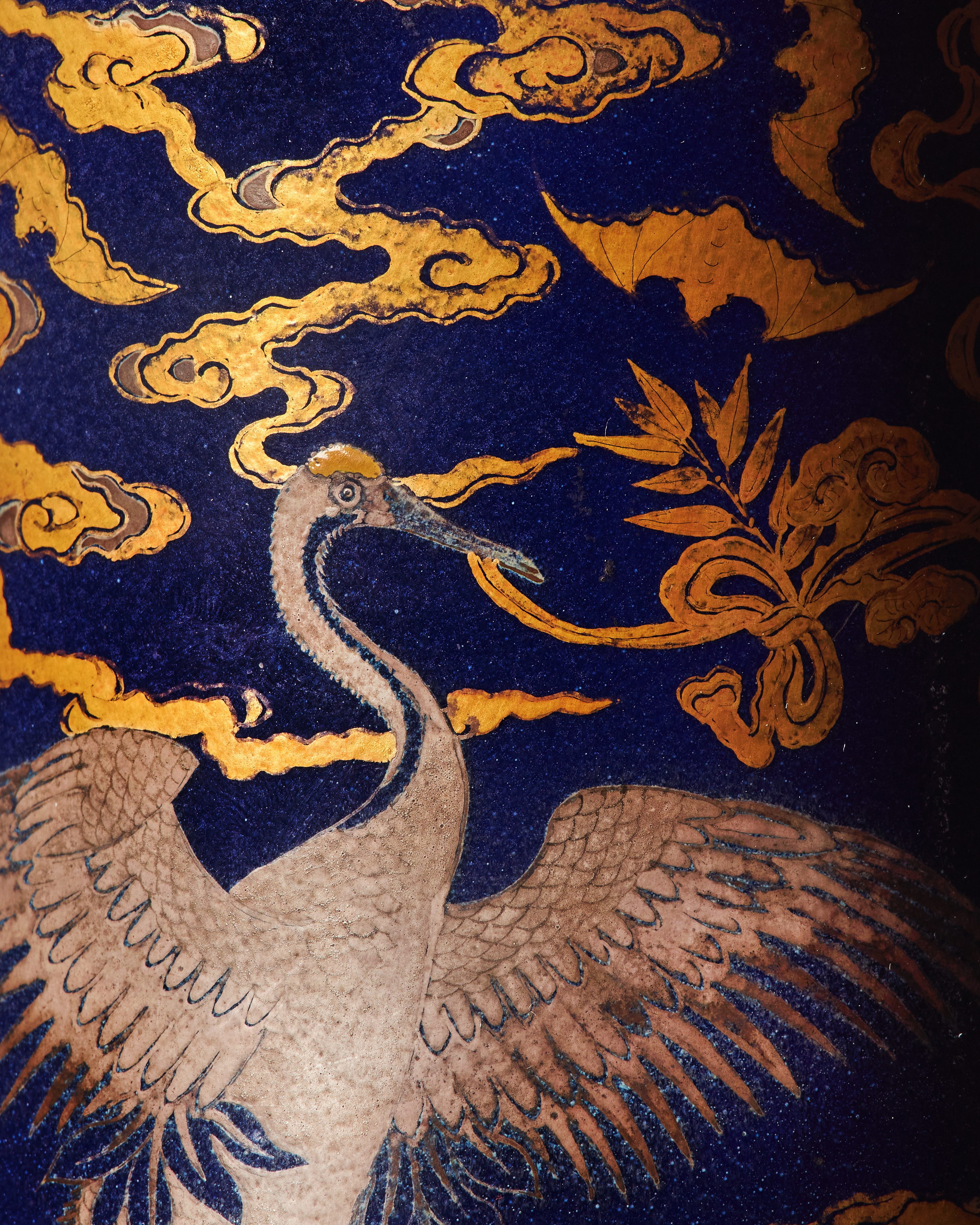 A silver crane and golden bats on a blue background